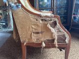 a chair that has been torn off and is sitting on the carpet