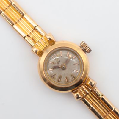 an image of a close up of a wrist watch on a white surface