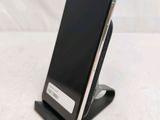 a cell phone that is on a stand on a table