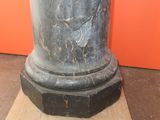 a black marble pedestal with a clock on top of it