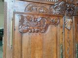 a large wooden cabinet with carvings on the top of it