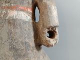 a close up of a vase with a hole in it