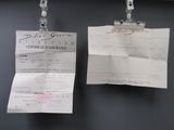 two pieces of paper hanging on a clothes line