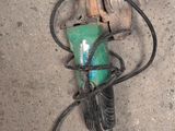 an image of a green and black drill on the ground