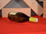a bottle of wine sitting on a table with a red table cloth
