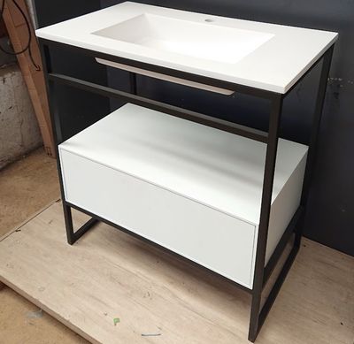 a white sink and a black stand in a room