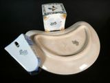 a cell phone sitting on top of a plate next to a box