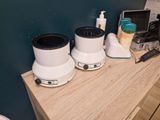 two blenders sitting on top of a wooden counter