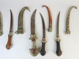 several different types of knives are displayed on a white surface