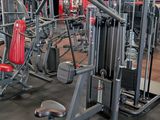 a gym room with a lot of equipment in it