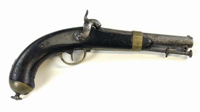 an old gun that is on display on a white surface