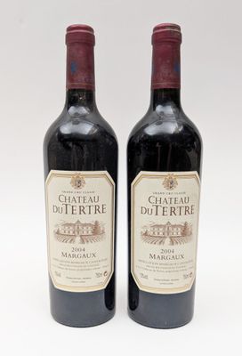 deux bouteilles de vin rouge posées l'une à côté de l'autre sur une surface blanche