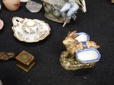 many different types of porcelain figurines on the table