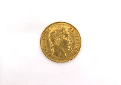 a close up of a gold coin on a white surface