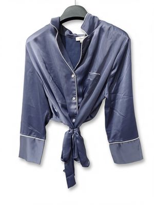 navy blue satin shirt with white pips and a tie around the collar