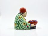 a figurine of a man holding a bowl