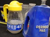 a blue jug and a yellow jug sitting next to each other on a table