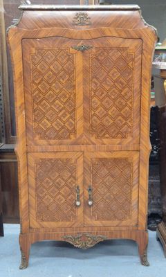 a wooden cabinet that is sitting in a room