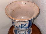 a blue and white bowl sitting on top of a wooden table