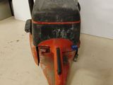 an orange and black machine sitting on top of a white floor