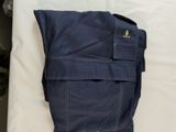 a bag that is laying on a bed with a pillow