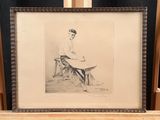 framed drawing of a woman sitting at a table with a book