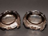 pair of silver plated ashtrays with a label on the top