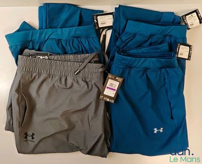 three pairs of men ' s under armour shorts on a table