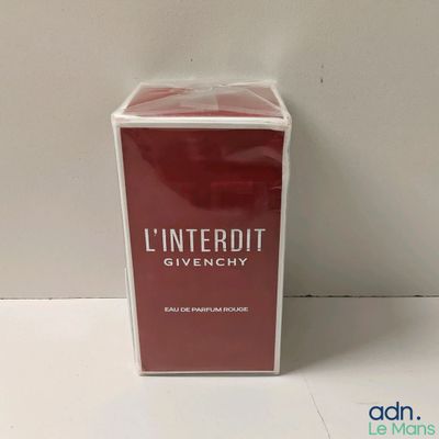 an image of a box of perfume sitting on top of a table