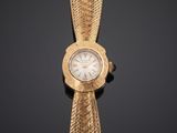 a close up of a gold wrist watch with a white dial