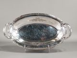 a silver plate with a mirror in the middle of it