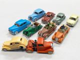 several toy cars are lined up in a row on a white surface
