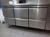 a large stainless steel oven in a kitchen next to a counter
