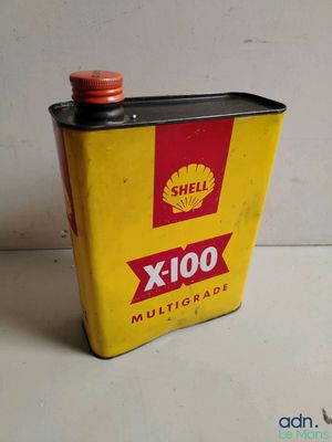an old shell oil can sitting on top of a table