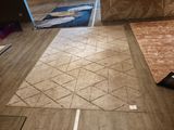 a picture of a living room with wood floors and a rug