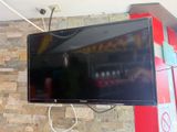 a flat screen tv mounted on a brick wall