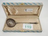 a silver spoon in a box with a price tag on it
