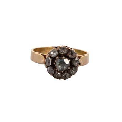 an image of a gold ring with a cluster of black diamonds