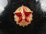 a red and gold star on the front of a black car