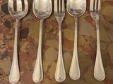 five silver spoons and six silver spoons on a table