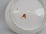 a white plate with a brown spot on it