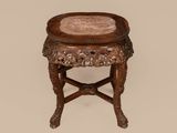 an old wooden table with a marble top on a beige background