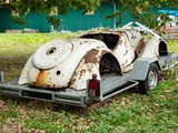 an old car that is sitting on the back of a trailer