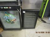 two refrigerators sitting next to each other on the floor