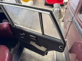 an old car with a broken window in the back of it
