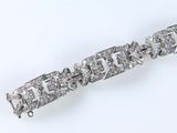 an image of a diamond bracelet on a white surface