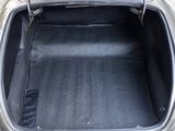 a trunk of a silver car with a black seat cover
