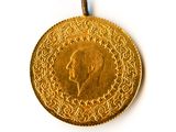 an image of a gold coin with a portrait of a man on it