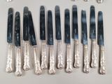 a lot of silverware on a table with a spoon and knife