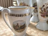 a lot of cups and saucers sitting on a table